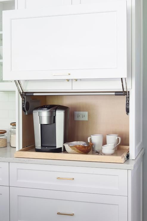 A comfortable coffee station with a raising door and a retractable shelf is a cool idea to hide the bar when not in need.
