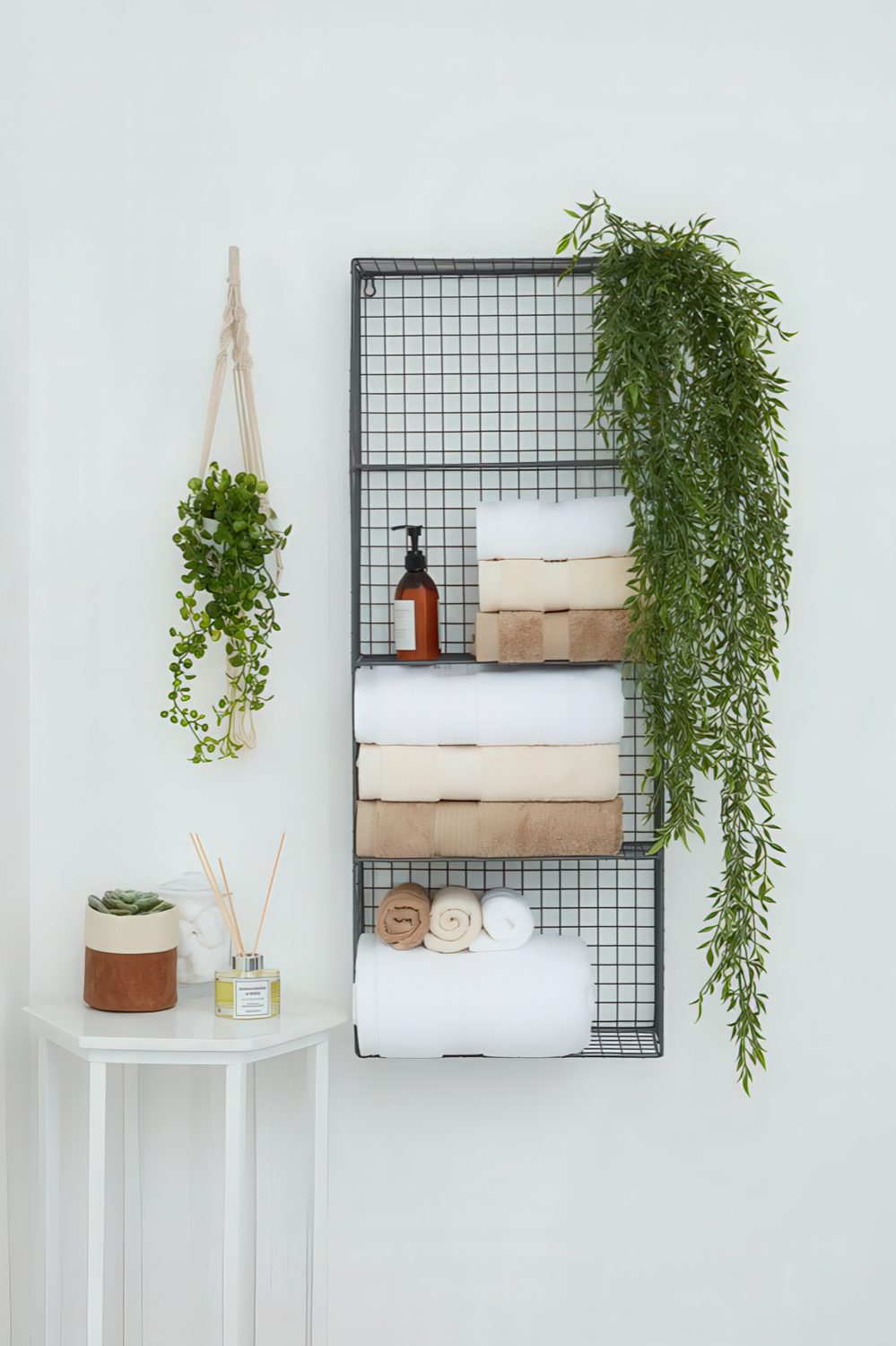 A metal wall shelf for storing towels, soaps, greenery in pots is a nice solution to save some floor space.