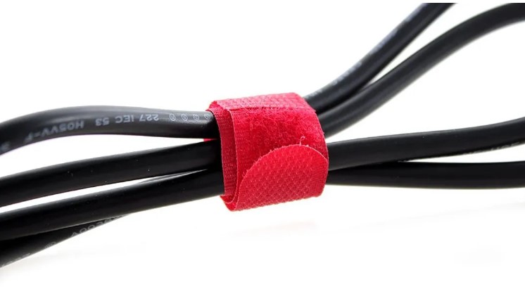 Use Velcro cable ties to wrangle your cords, they are cheap and easy to remove and can be rocked to hide any cords, not only those of the TV.