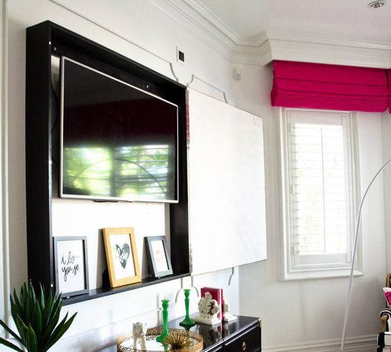 A box with a TV inside and a gorgeous artwork on the outside is a cool idea for every room, especially for a bedroom.