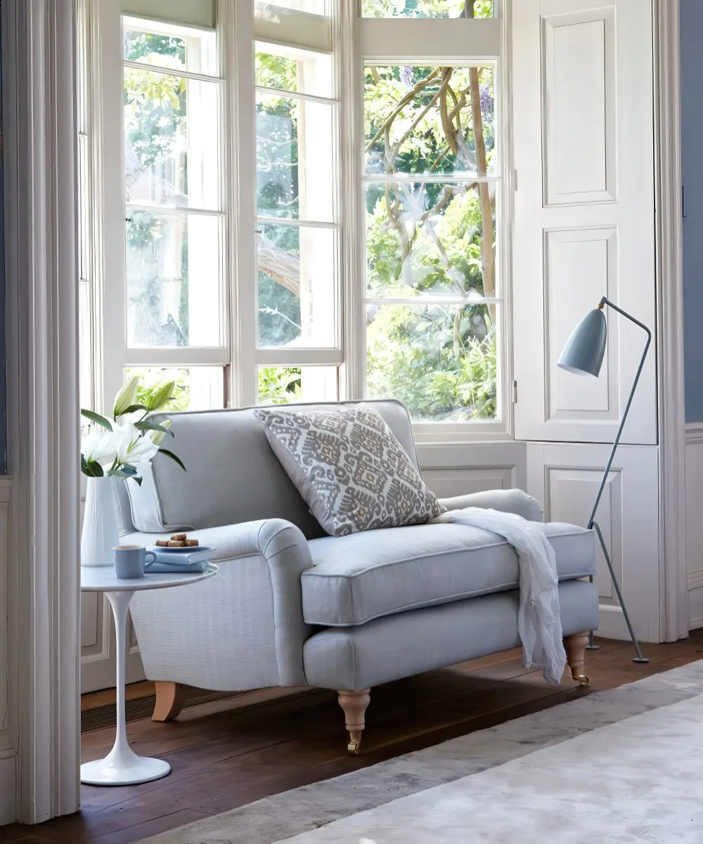 A corner with a comfy upholstered sofa, a side table and a matching floor lamp is a perfect reading nook.