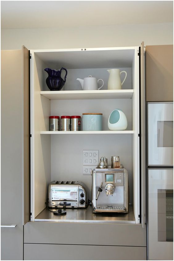 A kitchen cabinet with bi-fold doors is an ideal storage space for hiding all your appliances, especially those that you don't use very often.