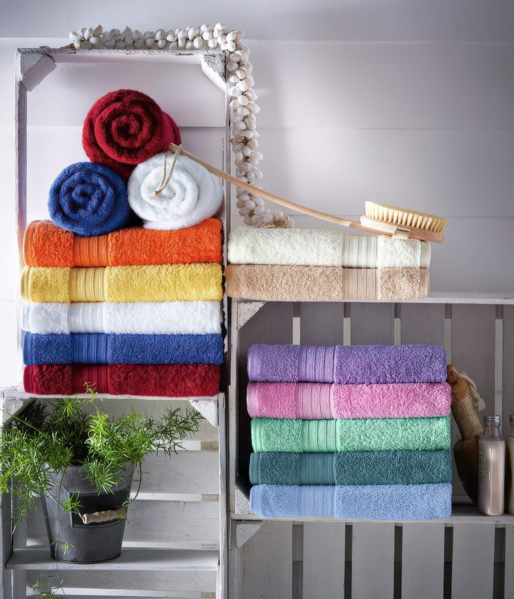 Crates repurposed into wall shelves to store towels, a plant and other bathroom stuff you may need.