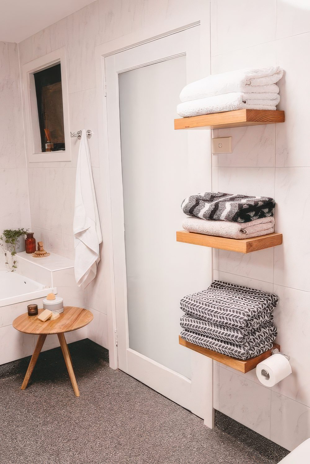 Floating shelves for towels don't look bulky and don't clutter your bathroom, this is a cool solution.