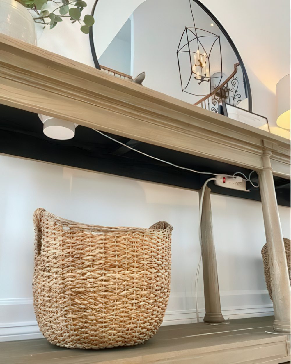 A basket placed under a console table is a lovely way to hide your router or you can attach it to the tabletop as cables.