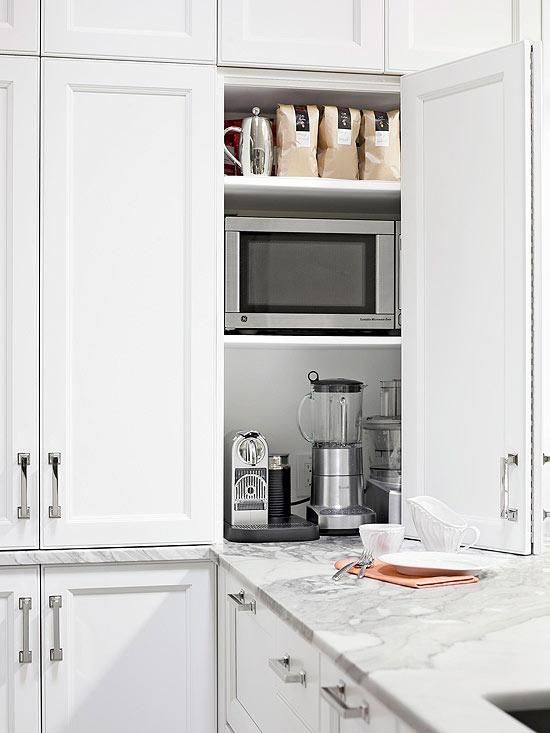 A small and comfortable cabinet with various kitchen appliances and some tea and coffee related stuff is amazing.