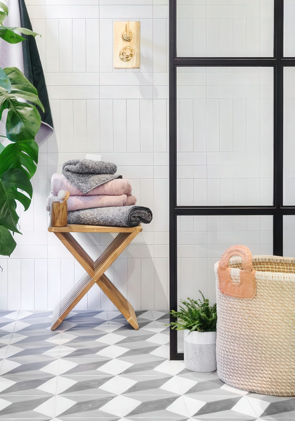 A small wooden stool is a nice storage unit, you can also sit on it, so get a folding one for your bathroom.