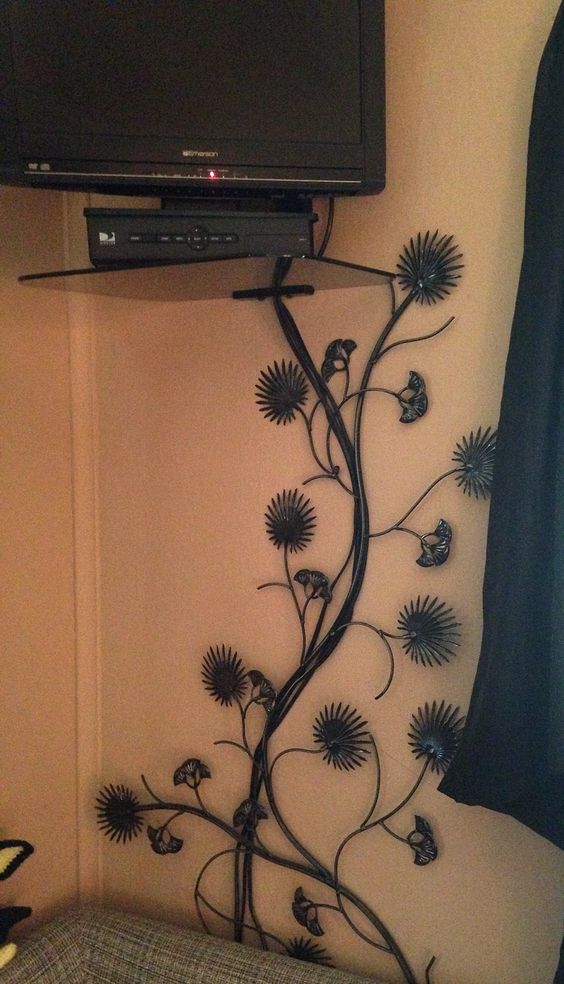 Find a vine like wall decoration and place it over the cords, it's a smart and cool idea and it will make your space more beautiful.