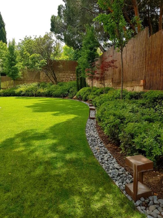 Rock edging adds texture to the landscape design and separate the shrubs and the lawn.