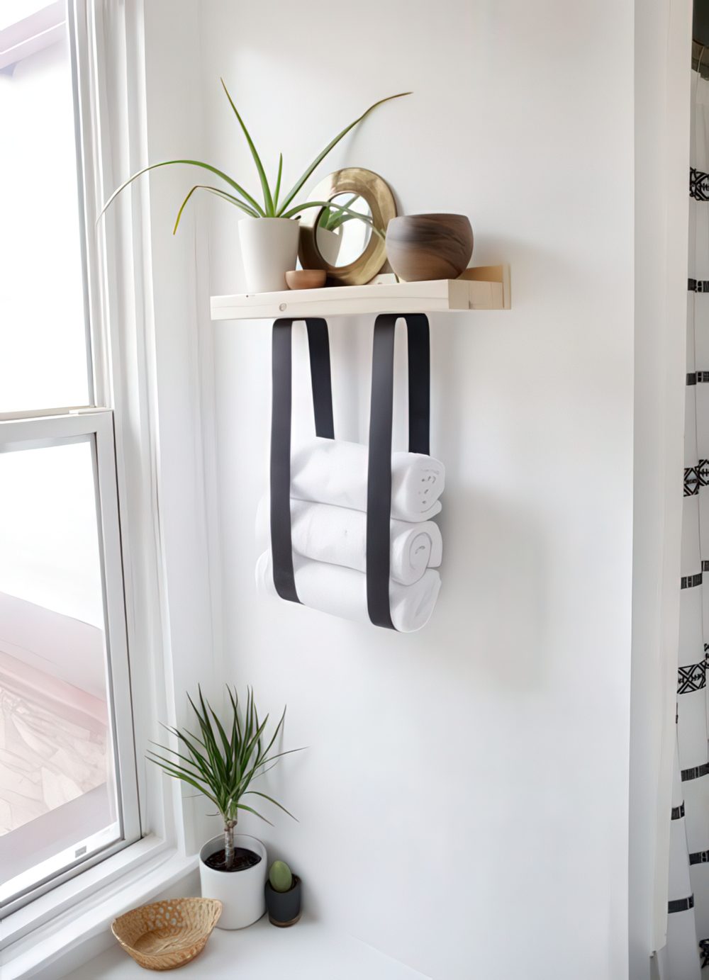 A wood and leather strap towel shelf will let you store not only towels but also decor and accessories.