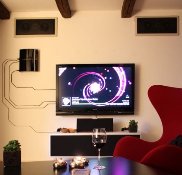 Hide your TV wires in plain sight - turn them into a real artwork using clear plastic cable slips, tape and adhesive.