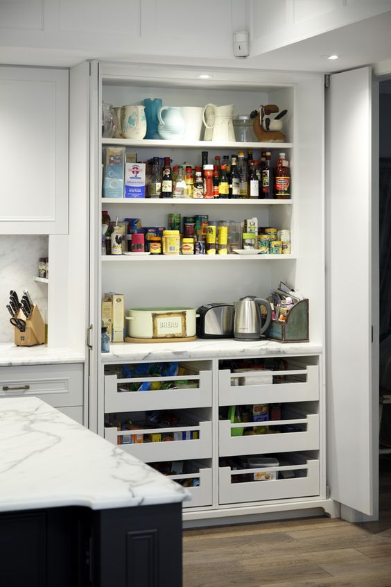 A small built-in pantry that keeps small appliances, too, and the doors are both sliding and folding to comfortably use everything.