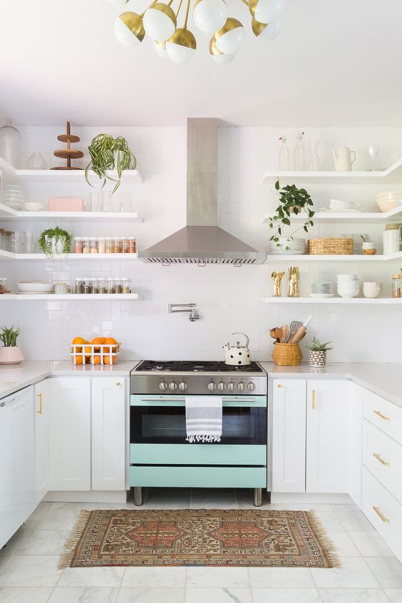 A mint colored cooker makes a soft colorful statement in this neutral space.