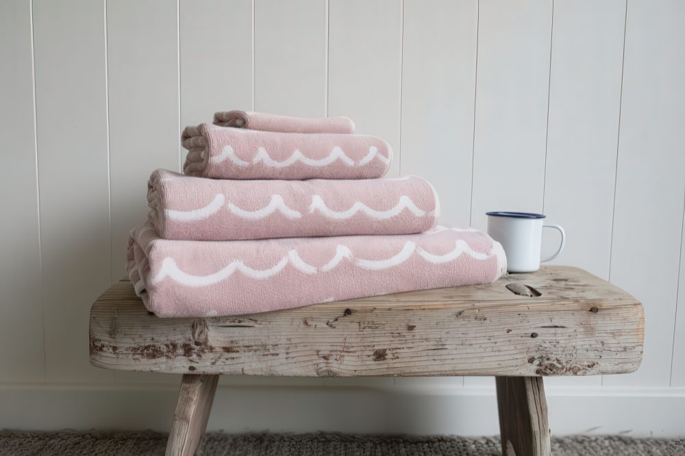 A rustic side table or bench will always add a natural touch to the space and you can store towels on it.
