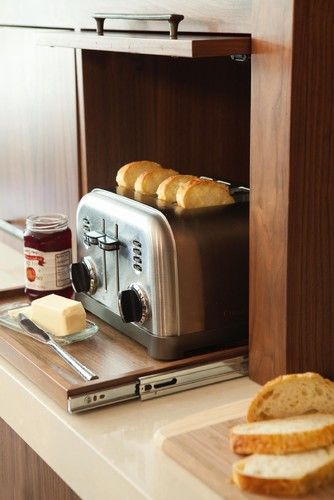 A small retractable shelf and a lifting up cabinet door for hiding the toaster - you can easily get it when needed.