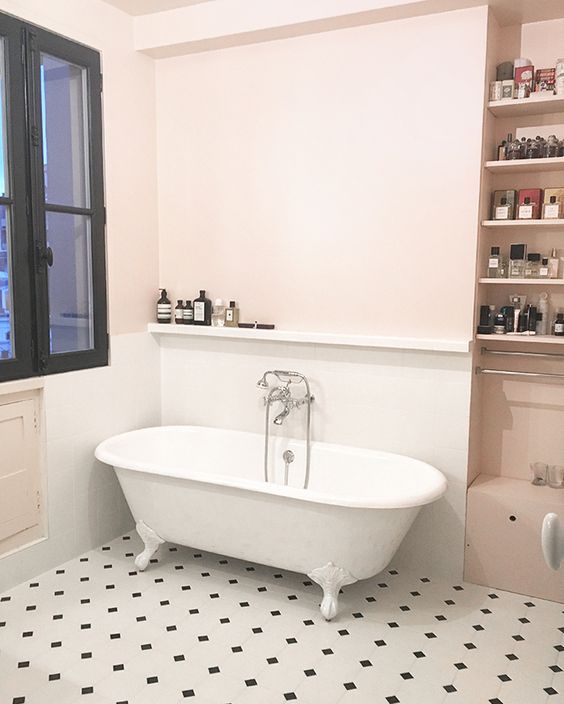 Very light pink walls and a mosaic tile floor create a refined and modern look.