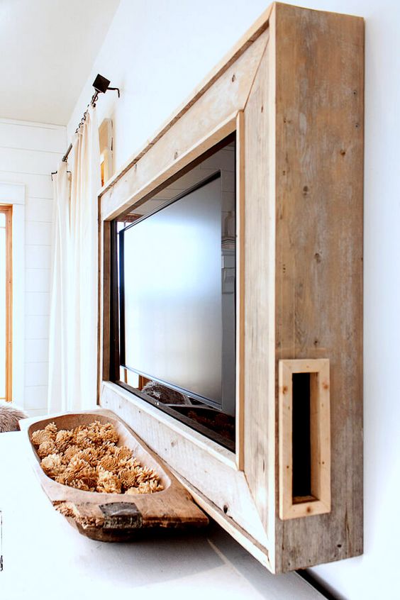 A salvaged wood frame box will hide all the wires away and will continue the rustic decor theme of your space.