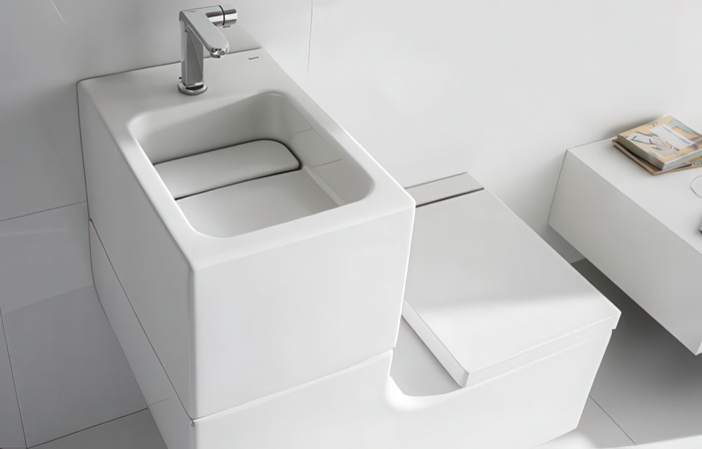 Stylish curved white sink and toilet combo.