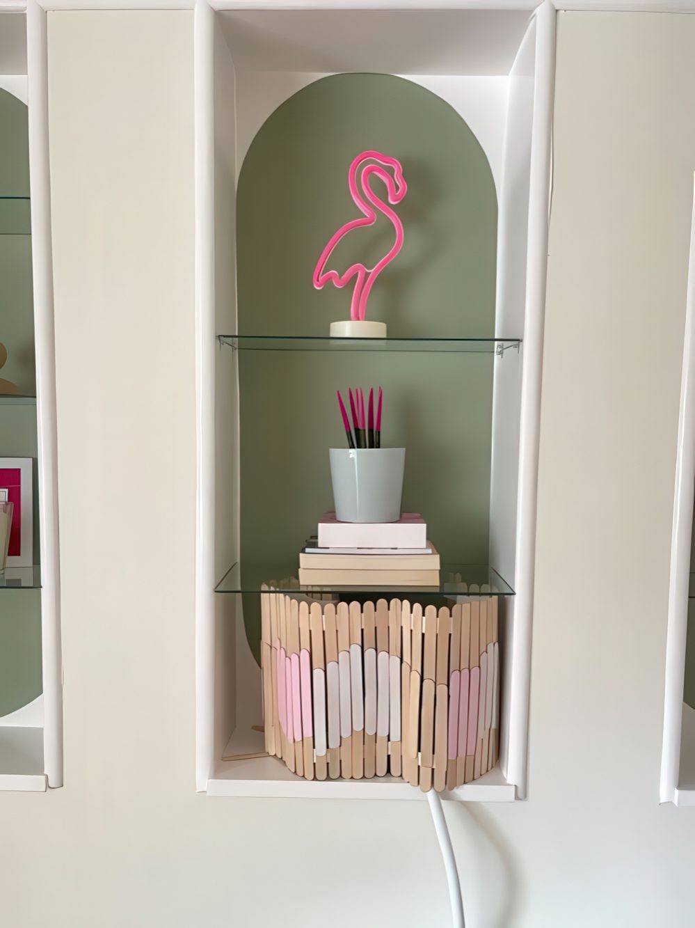 A simple popsicle stick screen with a touch of color is an easy DIY to hide your wi-fi router easily and make it look fine.