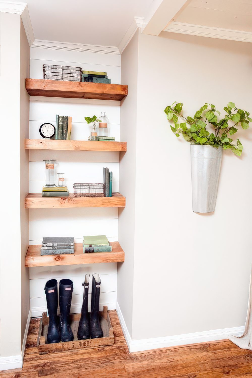 A small awkward nook taken by open shelves and is used for storage to make the use of it.