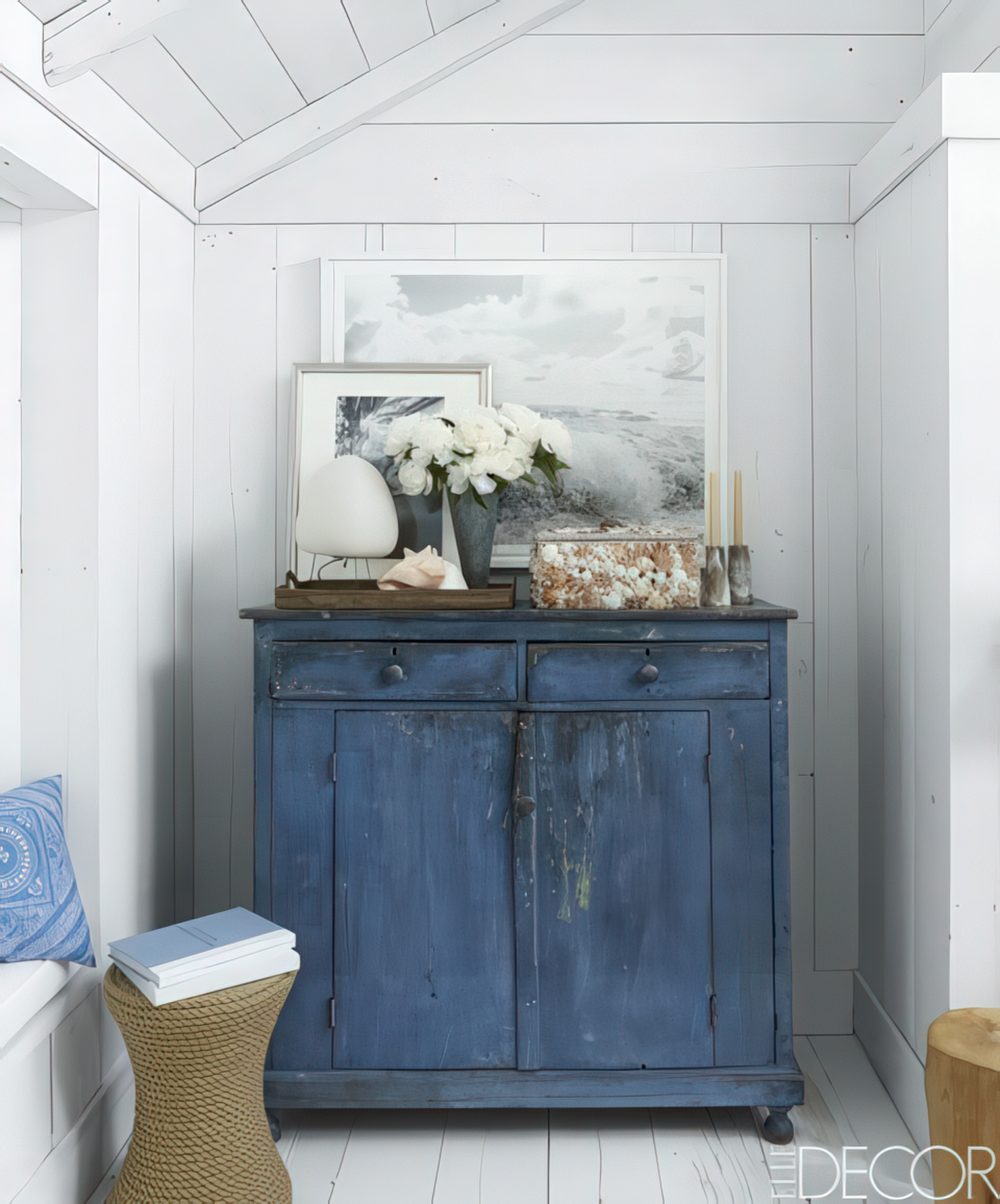 A colorful shabby chic cabinet is another great idea for storage in an awkward corner.