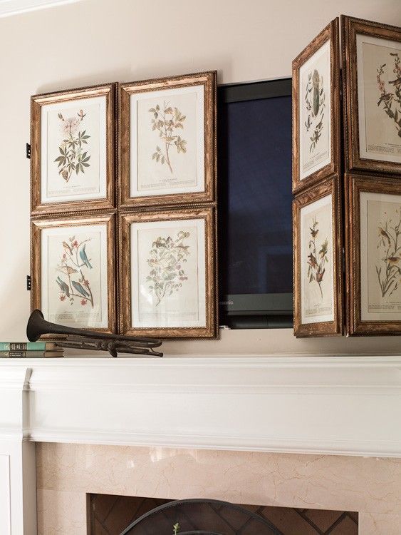 A TV over the fireplace hidden with a lovely gallery wall of vintage botanical posters is a lovely idea for a space with a vintage feel.