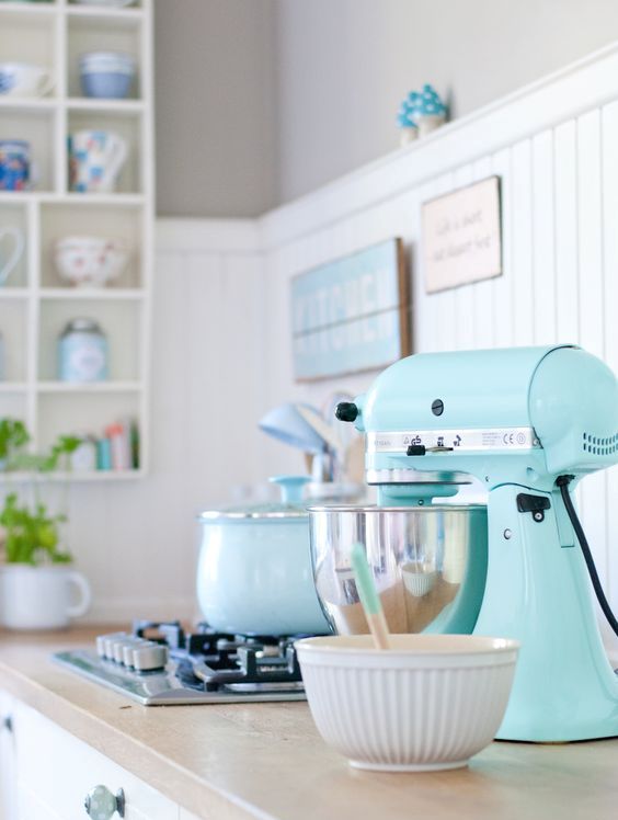 A pastel kitchen look can be polished with a mint mixer.