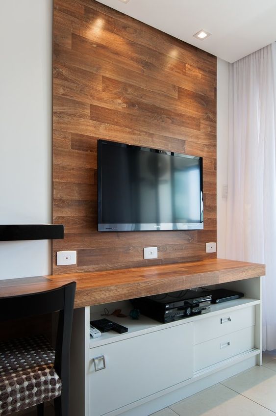 A wooden faux wall to highlight the TV and hide all the wires behind it adds a cozy rustic feel to the space and makes it cooler.