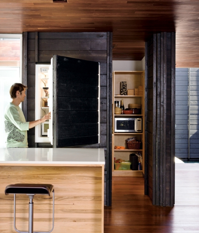 A fridge hidden inside a large cabinet doesn't spoil the look and style of your kitchen and looks absolutely integrated.