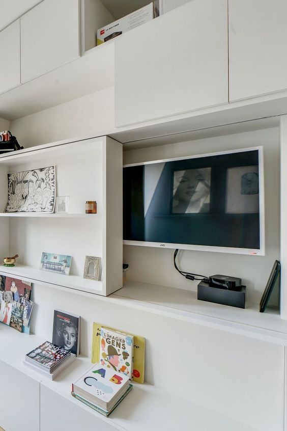 A TV hidden under a shelving unit that can slide and let you watch TV - this is a stylish and cool idea.