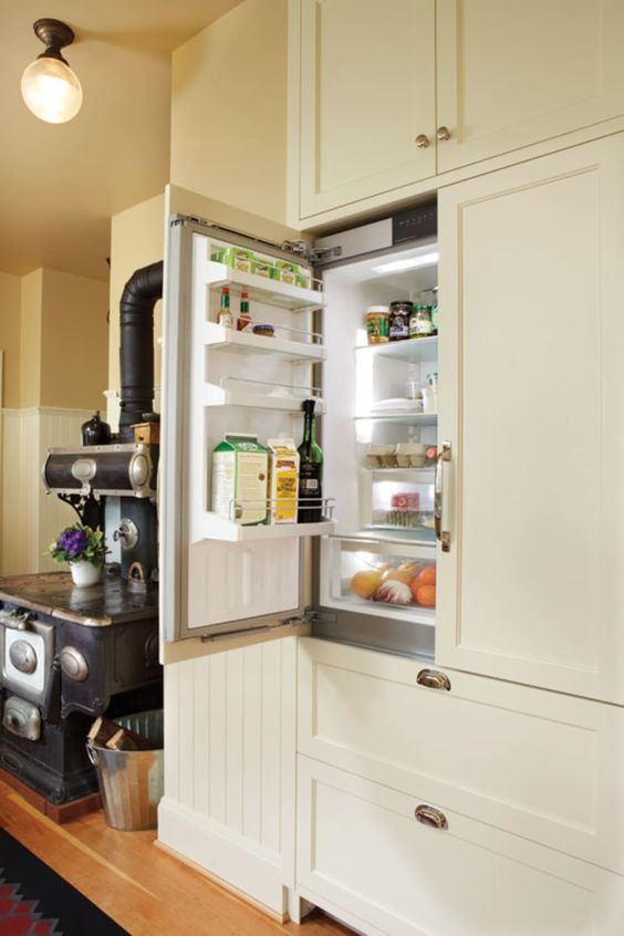 A fridge hidden inside kitchen cabinets to keep the look of the space sleek and elegant, without disturbing the style.