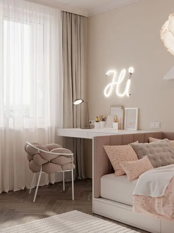 A beautiful white and dusty pink teen girl bedroom with various printed textiles, a neon light and a table lamp.