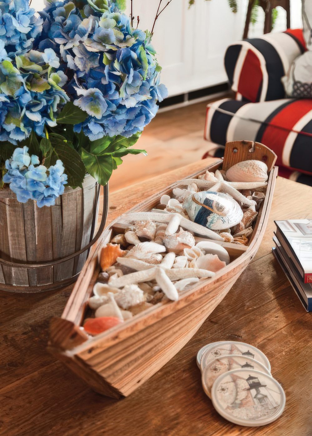 A boat filled with seashells and starfish is a nice decoration for any seaside space.