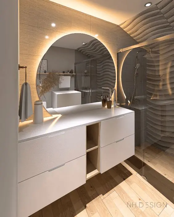 A contemporary bathroom with a large white vanity built of IKEA Metod, a round mirror with light and a shower space.