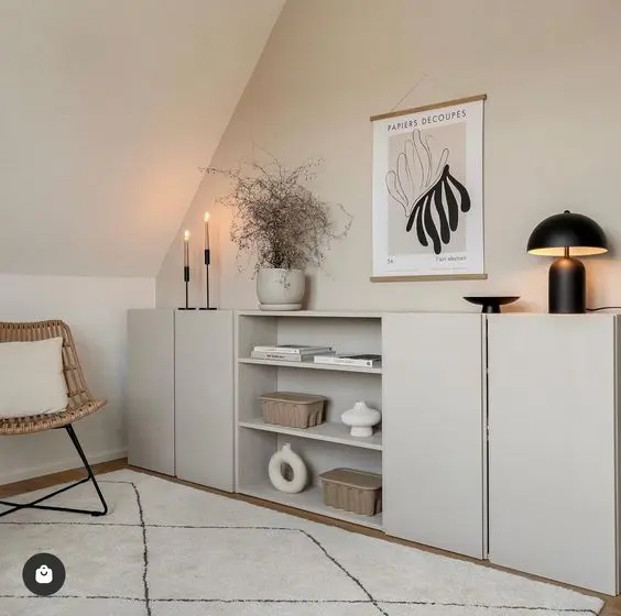 A dove grey sideboard made of IKEA Metod units, with shelves, candles, lamps and chic decor.