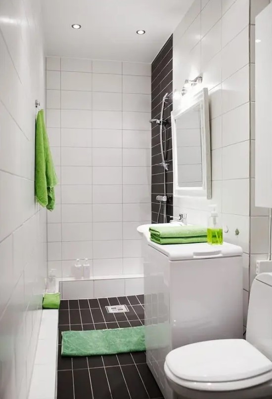A laconic contemporary bathroom done with white and chocolate brown tiles and accented with bright green elements.