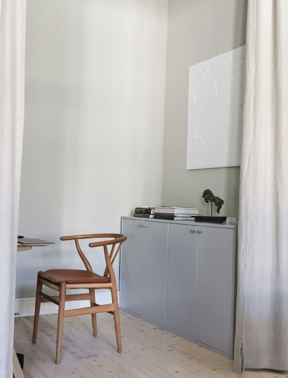 A light grey crendenza of two IKEA cabinets, wtih decor and books is a stylish idea for a Scandinavian space.