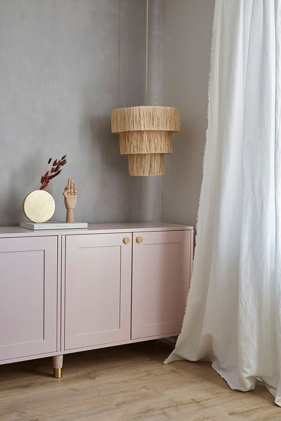 A light pink credenza of IKEA Metod cabinets, with shaker doors, gold knobs and legs is pure chic.