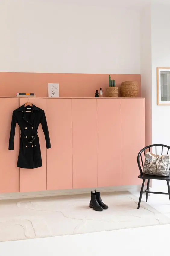 A peachy pink floating wardrobe of IKEA Metod units, with decor and books on top looks gorgeous.