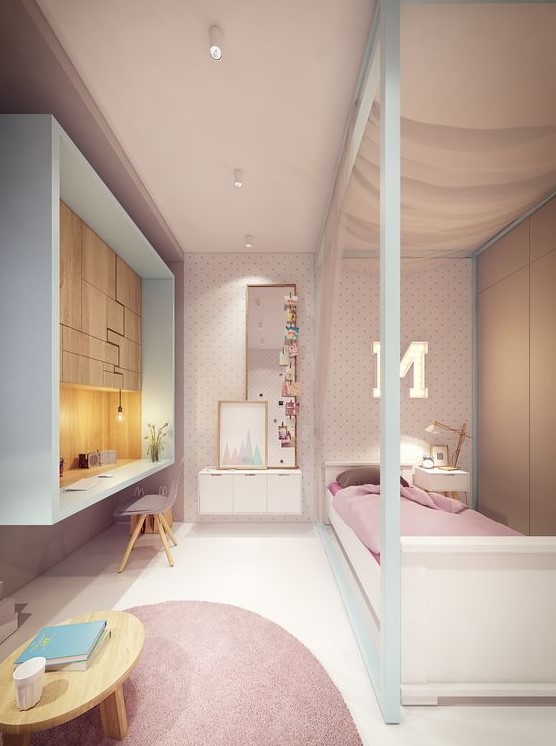 A pretty white and pink teen girl bedroom with a polka dot wall, pink textiles, a box-shaped studying zone with creative storage.