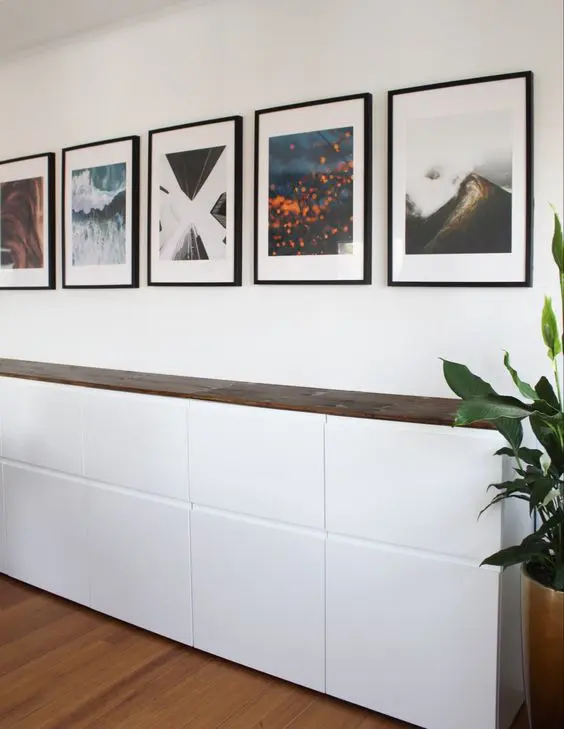 A Scandinavian sideboard created of IKEA Metod units and a dark-stained wooden countertop is a cool idea.