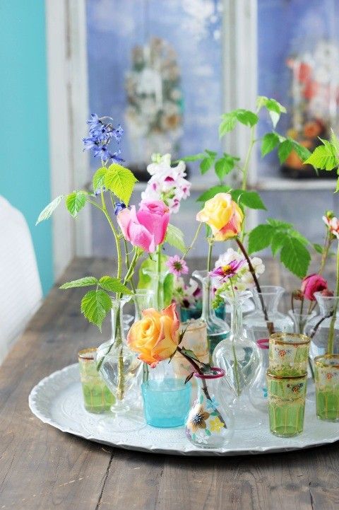 A vintage tray with elegant vases and glasses and bright blooms is a lovely summer decoration for any home.