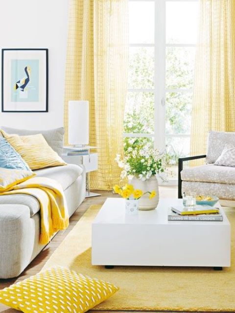 A vivacious living room with yellow curtains, a rug and some pillows feels sun-filled and very bright.