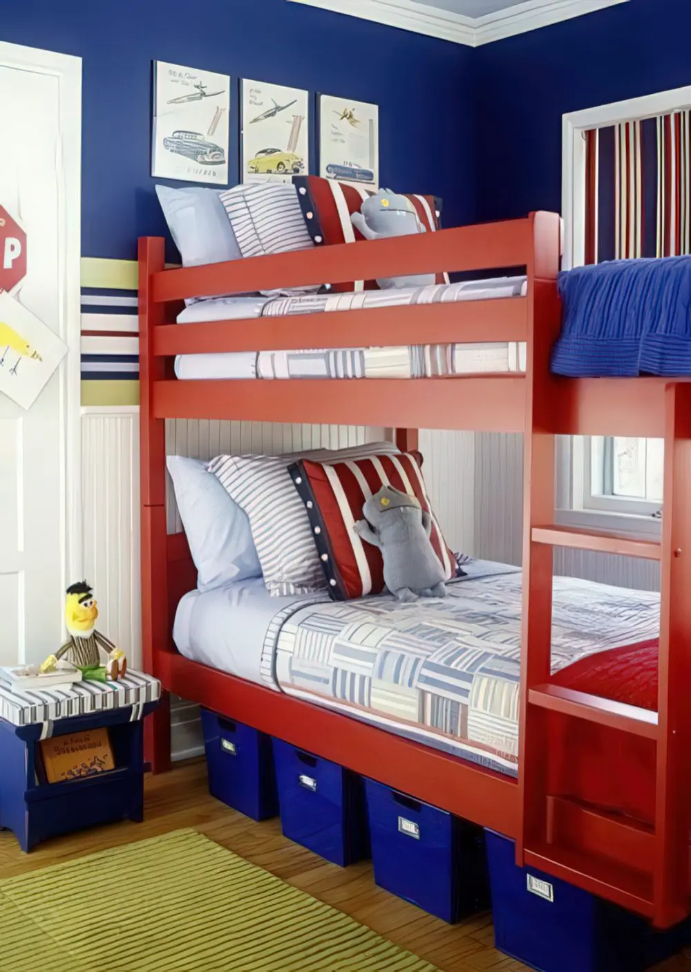 A striking bunk room with a bright red bunk bed, blue storage bins, and striped bedding in red, white, and blue. The combination of bold colors and playful details makes it a perfect space for kids.