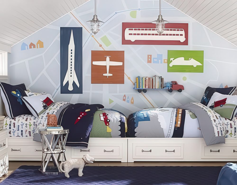 A creative shared bedroom featuring a custom-built bed platform with storage drawers and a large-scale city map mural. Airplane, train, and car wall art add to the transportation theme.