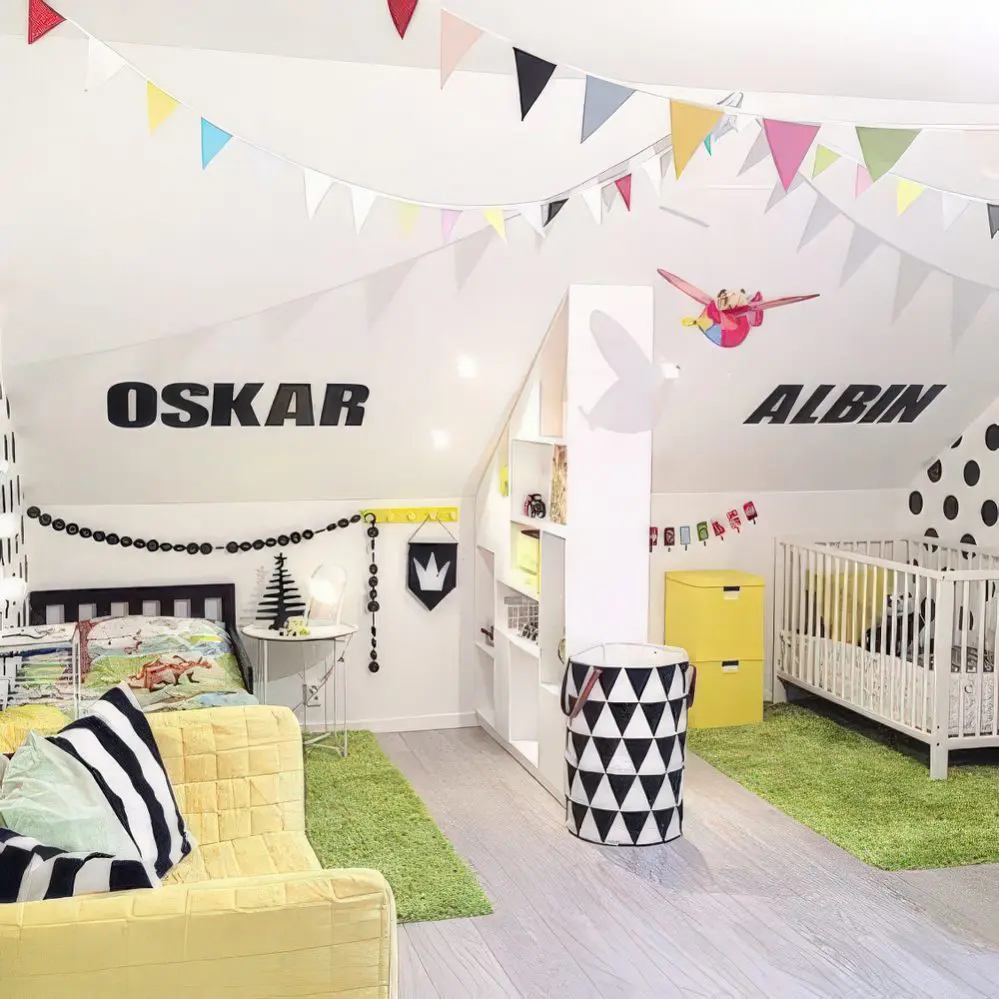 A stylish, Scandinavian-inspired attic bedroom with personalized name wall decals, cheerful bunting, and playful furniture. The mix of black, white, and yellow tones adds a modern yet playful charm.
