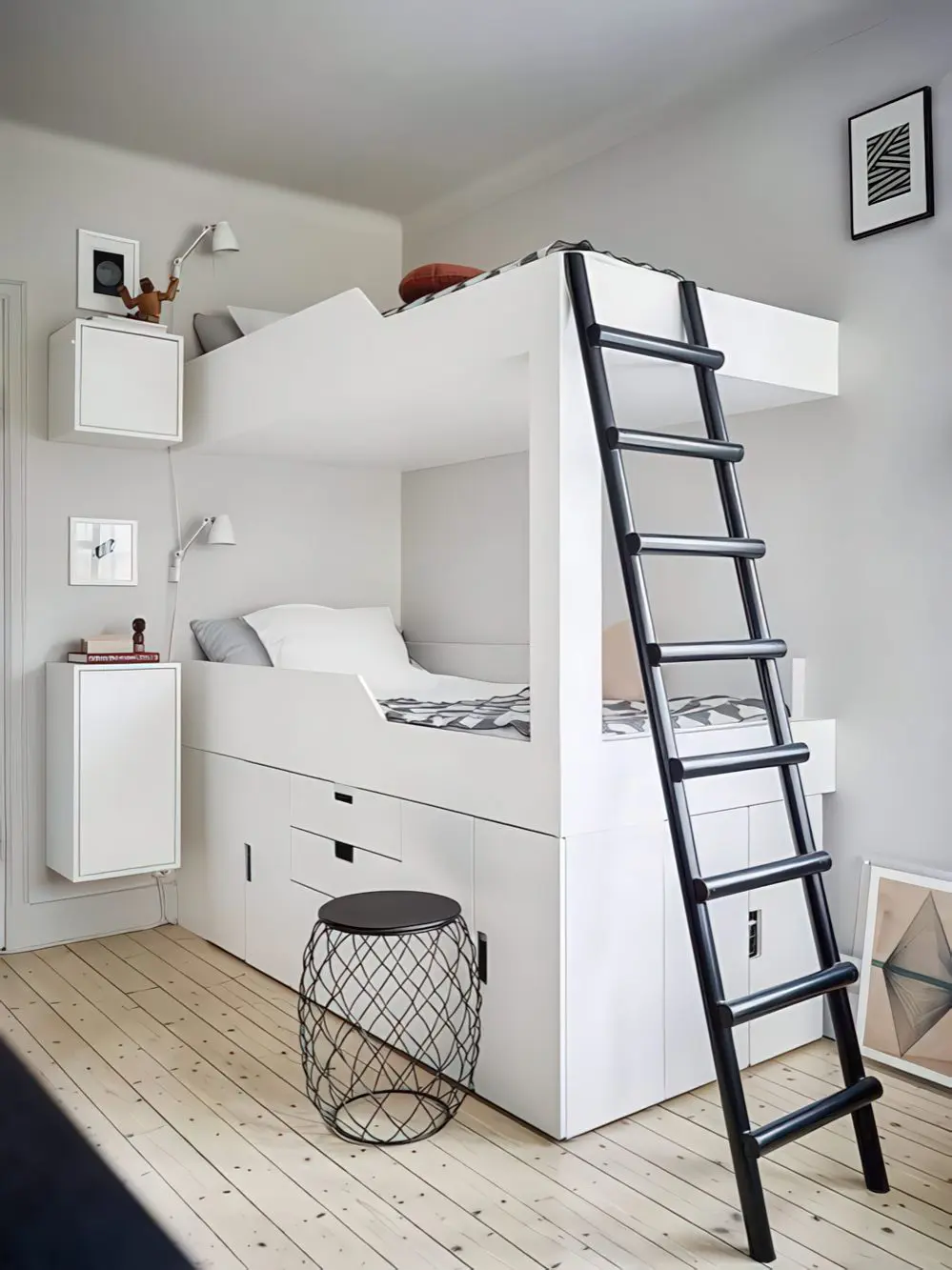 A sleek, space-saving bunk bed with a built-in lower sleeping area and an elevated top bunk, accessed via a black ladder. The white frame features integrated storage compartments, making it a stylish and functional solution for small spaces.
