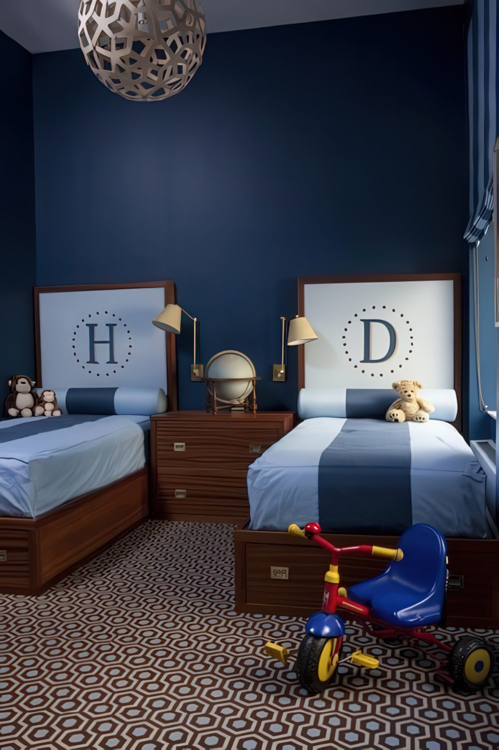 A sophisticated shared room featuring twin beds with dark wood frames, monogrammed headboards, and a rich blue color palette. The geometric-patterned carpet adds a modern touch, while warm wooden furniture and brass reading lights create a cozy ambiance.
