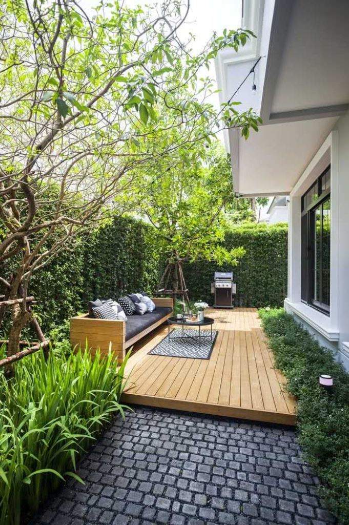 This long light-stained deck is a perfect space to create an outdoor living room with living walls and trees.