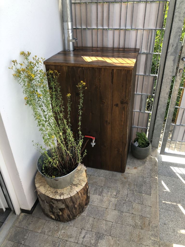 The barrel is hidden inside a stained box to make it look cohesive in the space, chic and sleek.